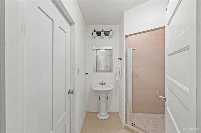 bathroom with tile patterned flooring and a shower stall