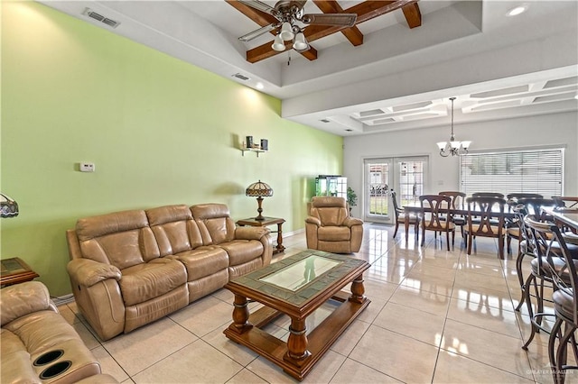 living area with light tile patterned floors, visible vents, a raised ceiling, and french doors