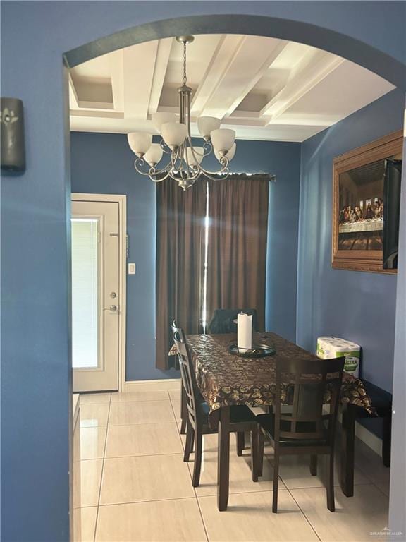 tiled dining area featuring beamed ceiling and a chandelier