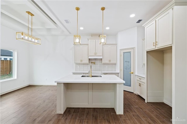 kitchen featuring tasteful backsplash, visible vents, and dark wood-type flooring