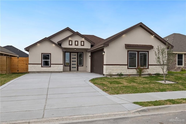 view of front of property with stucco siding, a front yard, fence, a garage, and stone siding