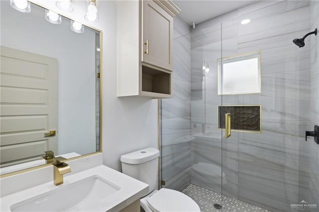 bathroom featuring a stall shower, vanity, and toilet