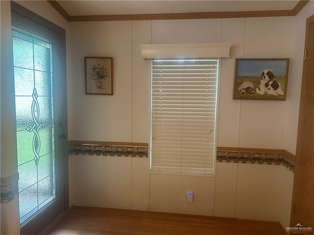 interior details with hardwood / wood-style floors and crown molding