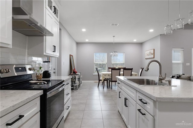 kitchen with stainless steel electric range, light tile patterned floors, visible vents, a sink, and wall chimney exhaust hood