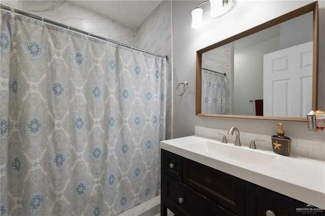 bathroom featuring curtained shower and vanity