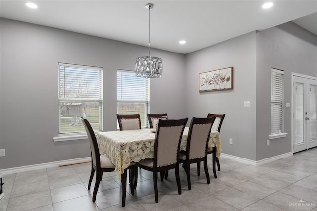 dining space featuring light tile patterned floors, recessed lighting, an inviting chandelier, and baseboards