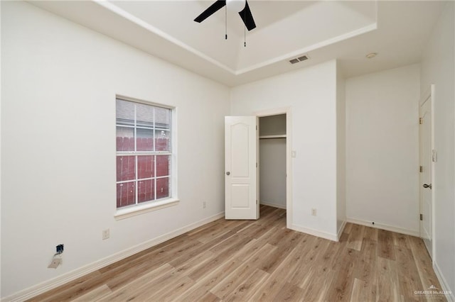 unfurnished bedroom with visible vents, baseboards, and light wood-style flooring