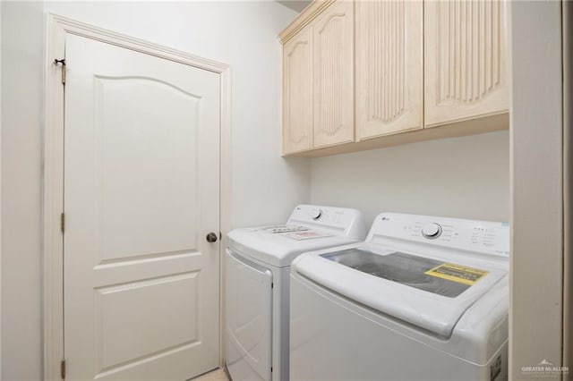 laundry area with cabinet space and independent washer and dryer