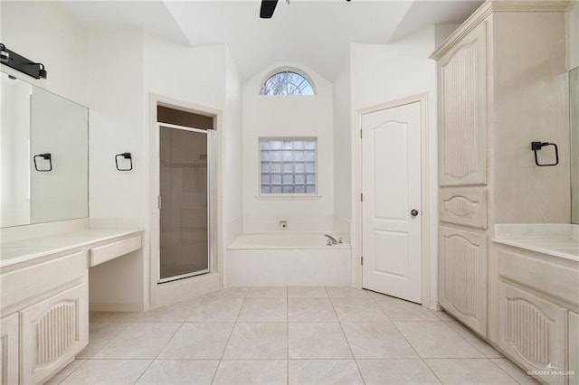 bathroom with a garden tub, a stall shower, a ceiling fan, tile patterned flooring, and vanity