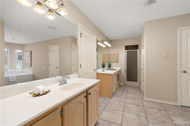 bathroom with tile patterned flooring, vanity, and walk in shower