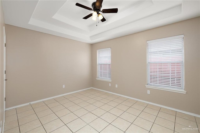 unfurnished room featuring ceiling fan and a tray ceiling