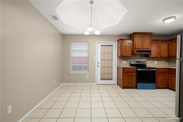 kitchen with a chandelier, light tile patterned floors, appliances with stainless steel finishes, pendant lighting, and backsplash