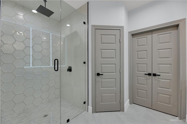 bathroom featuring a shower with shower door