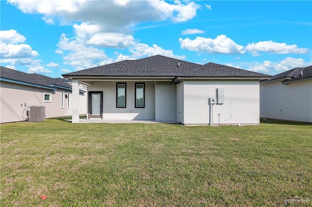 rear view of house with a yard, cooling unit, and a patio