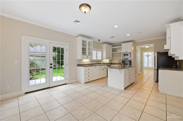 5501 N 1st Ln, Mcallen, TX 78504 - kitchen featuring appliances with stainless steel finishes, crown molding, a sink, healthy amount of natural light, and baseboards