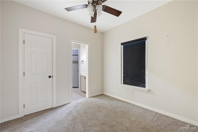 5501 N 1st Ln, Mcallen, TX 78504 - unfurnished bedroom featuring light colored carpet, baseboards, connected bathroom, and ceiling fan