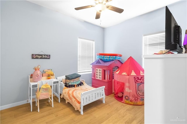 bedroom featuring baseboards, ceiling fan, and wood finished floors