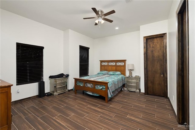 bedroom with ceiling fan and dark hardwood / wood-style floors