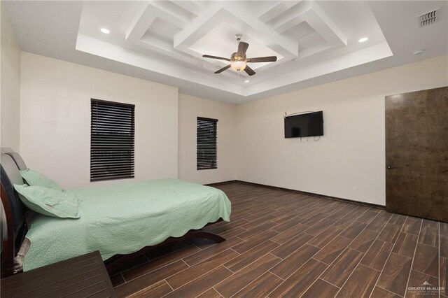 bedroom featuring a tray ceiling, ceiling fan, and dark hardwood / wood-style floors