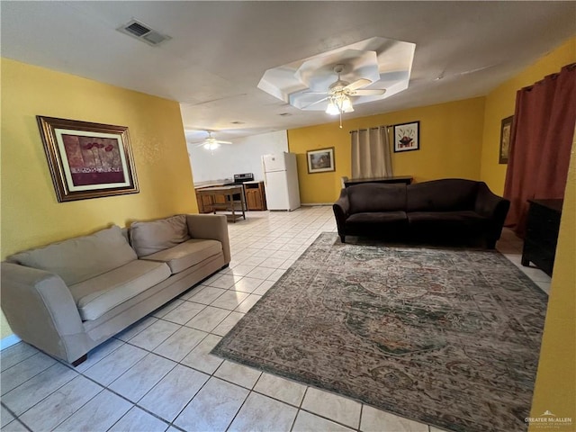 living room featuring light tile patterned floors and ceiling fan