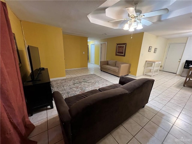 living room featuring light tile patterned floors and ceiling fan