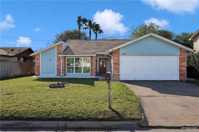 view of front of property featuring a front yard, fence, driveway, an attached garage, and brick siding