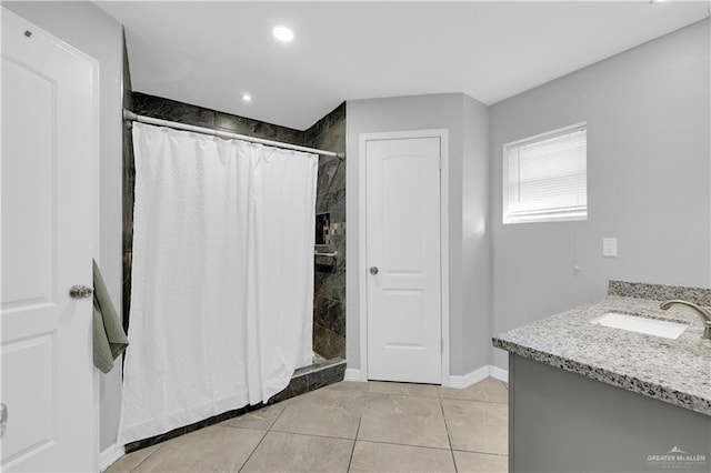 full bathroom featuring a tile shower, tile patterned flooring, recessed lighting, and baseboards