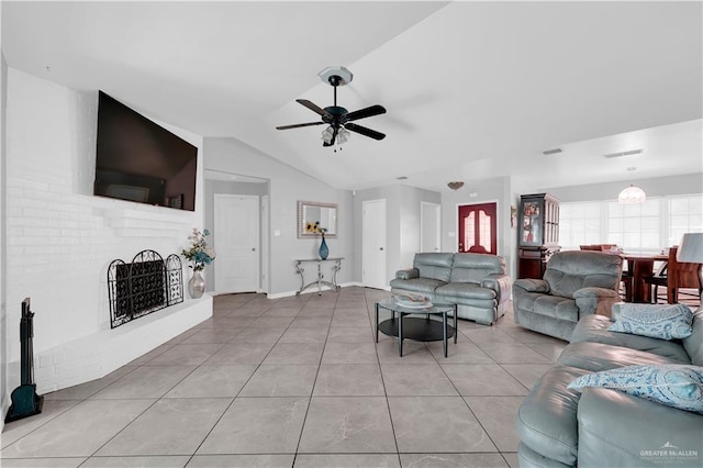 living room with vaulted ceiling, a brick fireplace, light tile patterned floors, and a wealth of natural light