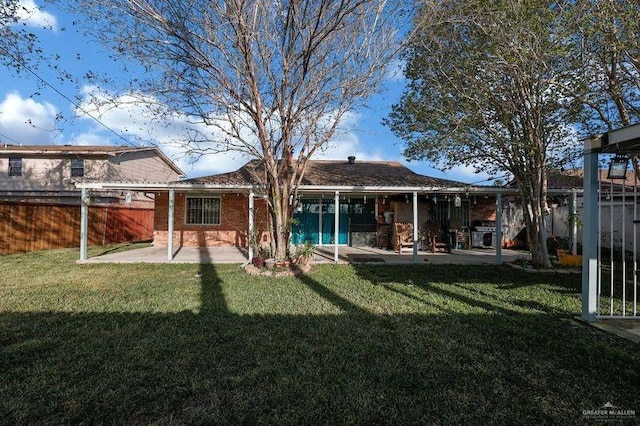 back of house with a yard, a patio, and fence