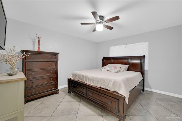 bedroom featuring light tile patterned floors, a ceiling fan, and baseboards