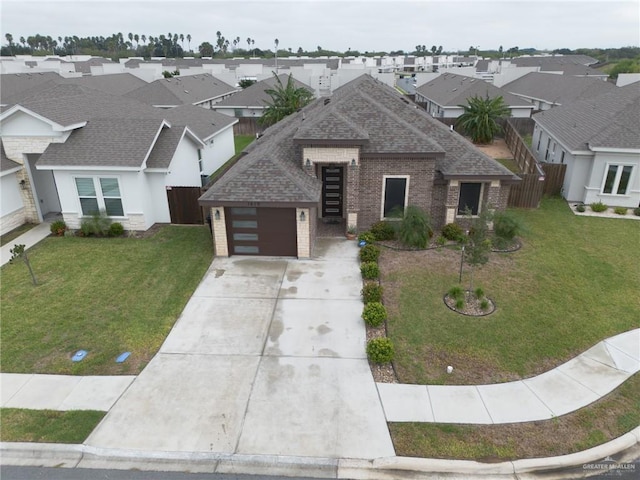 1419 Frente Al Mar Dr, Weslaco, TX 78596 - view of front of house with driveway, roof with shingles, brick siding, and a garage