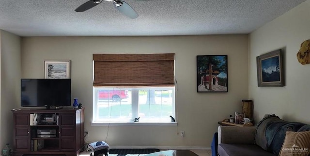 2219 Ella Ave, Harlingen, TX 78550 - living room featuring a ceiling fan, a textured ceiling, and baseboards