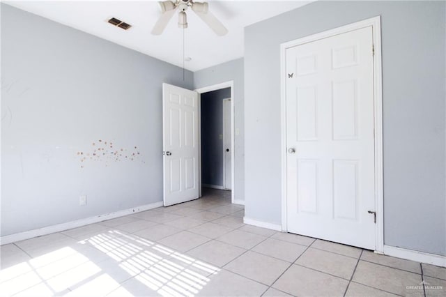 28099 Nelson Rd, San Benito, TX 78586 - unfurnished bedroom featuring light tile patterned floors, baseboards, and ceiling fan