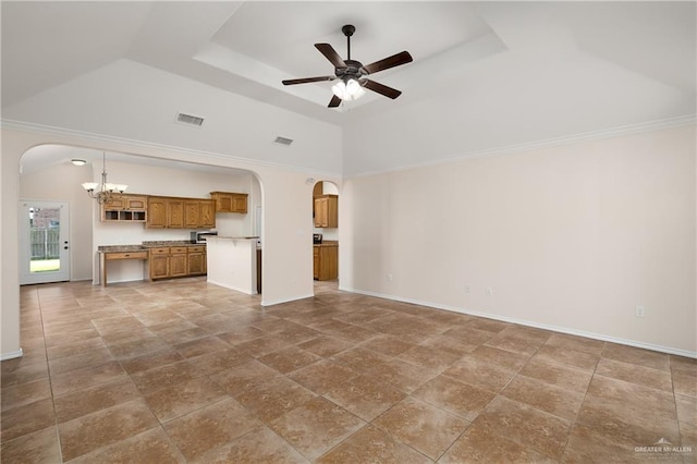 unfurnished living room with ceiling fan with notable chandelier and a raised ceiling