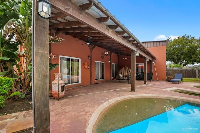 view of swimming pool featuring a pergola, a patio area, and ceiling fan