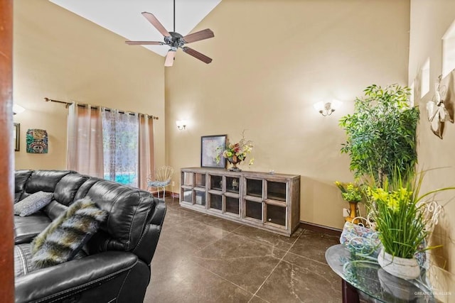 living room with ceiling fan and high vaulted ceiling