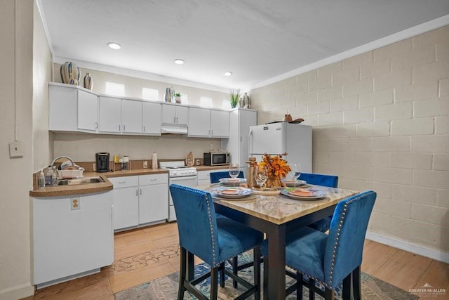 kitchen featuring white cabinets, white appliances, and sink