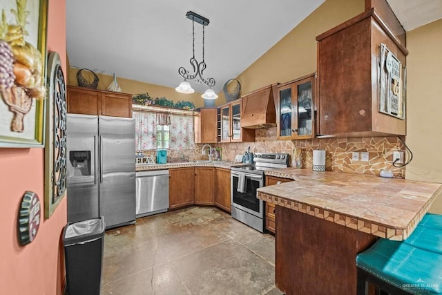 kitchen with kitchen peninsula, appliances with stainless steel finishes, premium range hood, hanging light fixtures, and a breakfast bar area