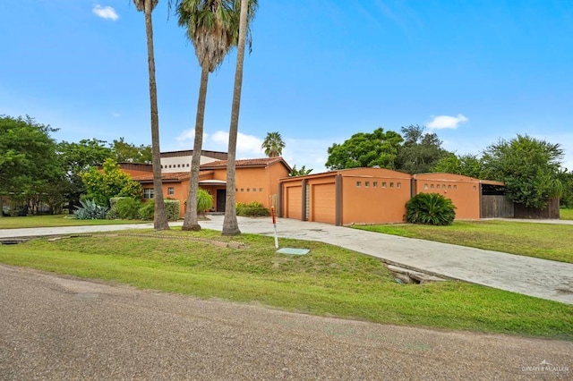 view of front of property featuring a garage and a front lawn