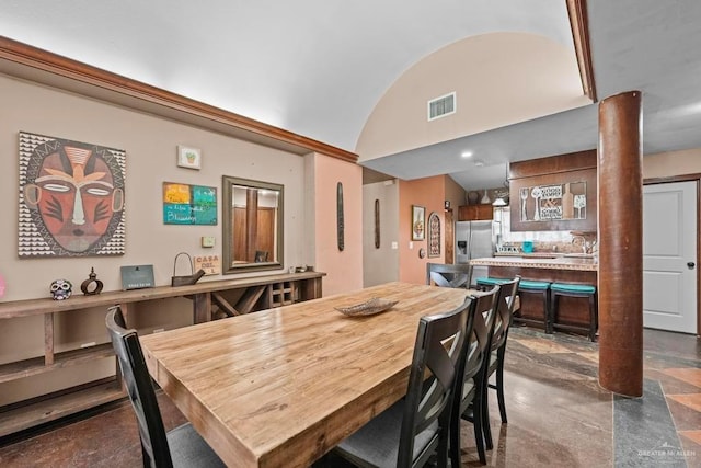 dining area featuring vaulted ceiling