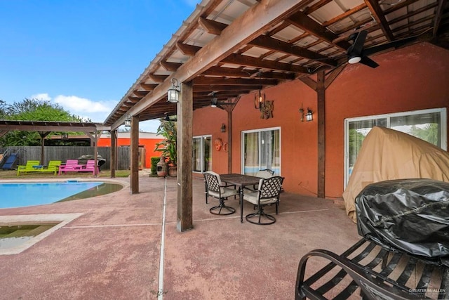 view of patio featuring a fenced in pool and ceiling fan