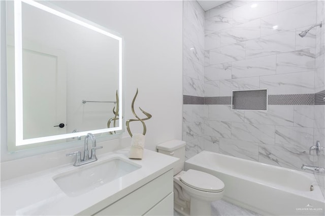 full bathroom with tiled shower / bath combo, toilet, and vanity