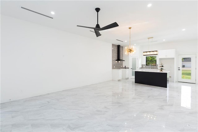 unfurnished living room with ceiling fan