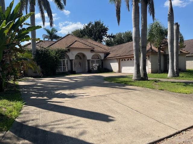 mediterranean / spanish home with a garage