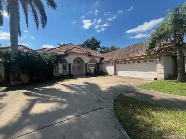 mediterranean / spanish-style home featuring a garage