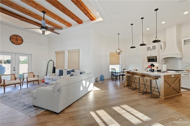 13801 N 37th St, Mcallen, TX 78504 - living room with a towering ceiling, beam ceiling, ceiling fan, light wood-style floors, and recessed lighting