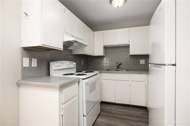 kitchen featuring white cabinetry, sink, white appliances, and backsplash