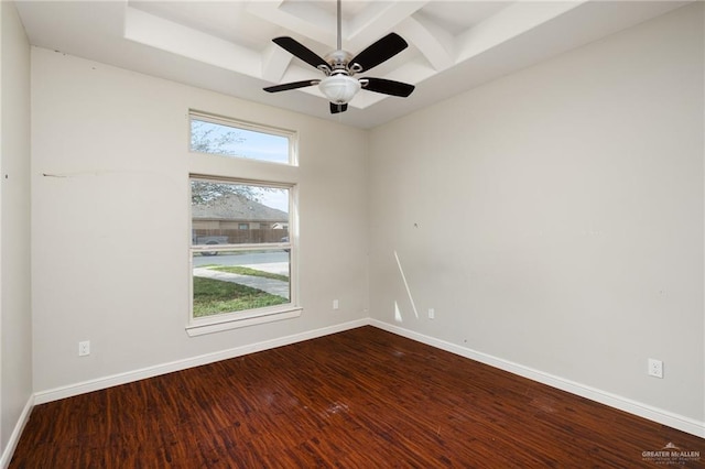 spare room with ceiling fan, coffered ceiling, baseboards, and dark wood-style flooring