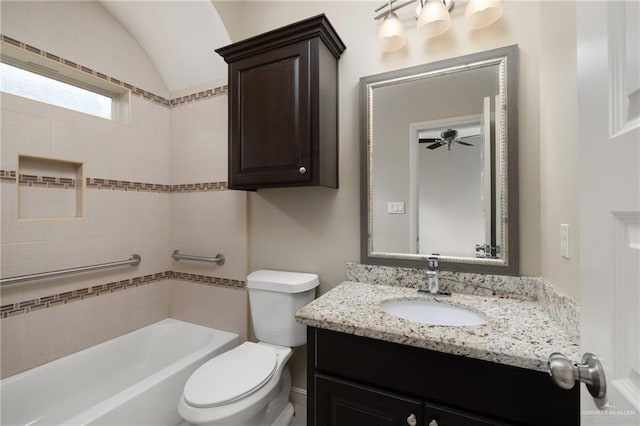 bathroom with washtub / shower combination, lofted ceiling, toilet, and vanity