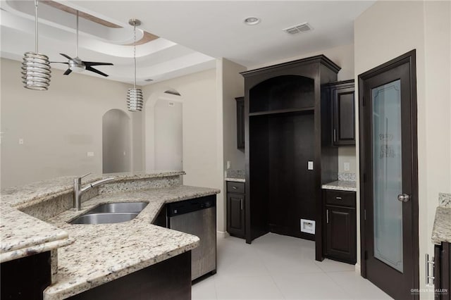 kitchen with visible vents, light stone countertops, dishwasher, a raised ceiling, and a sink